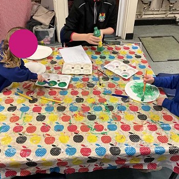 Children in the Christmas Craft club painting in the classroom
