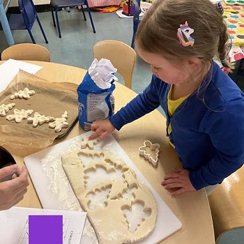 A child making christmas tree biscuits in the Christmas Craft club