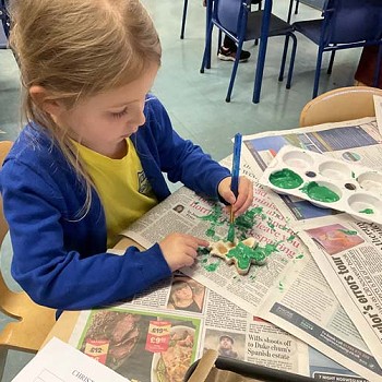 A child painting in the classroom