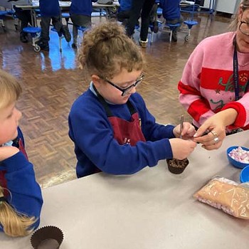 Children making cakes in the cookery club