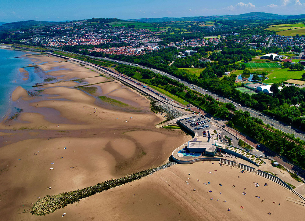 An aerial view of conwy showing the beach, houses and fields